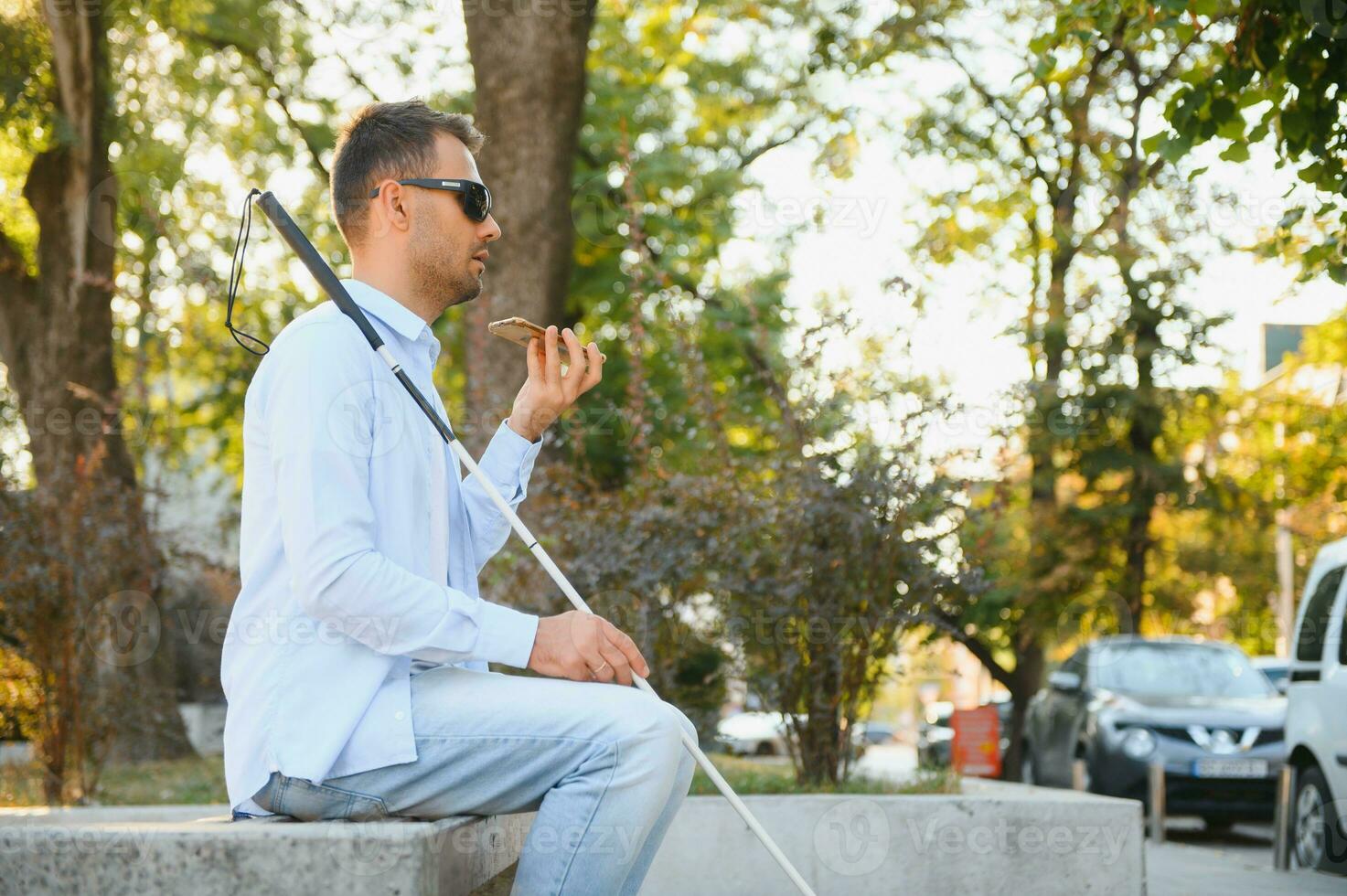 Blinded man waiting for bus at a bus station photo