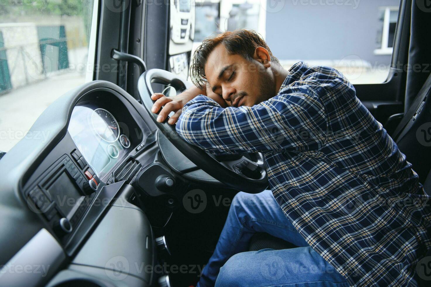Portrait of tired indian truck driver feeling sleepy and sick. photo