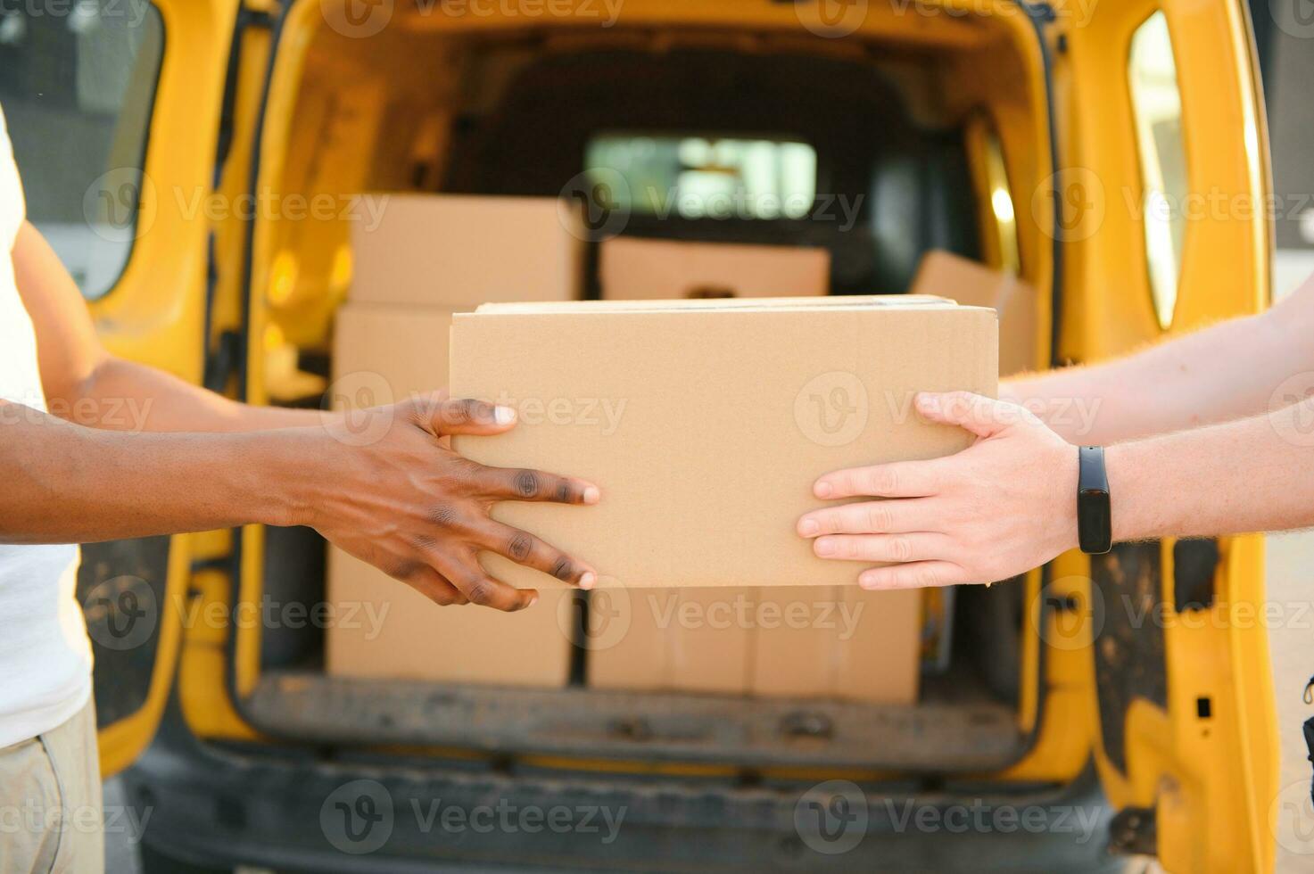 Cropped image of fast delivery service worker giving parcel to the client. photo