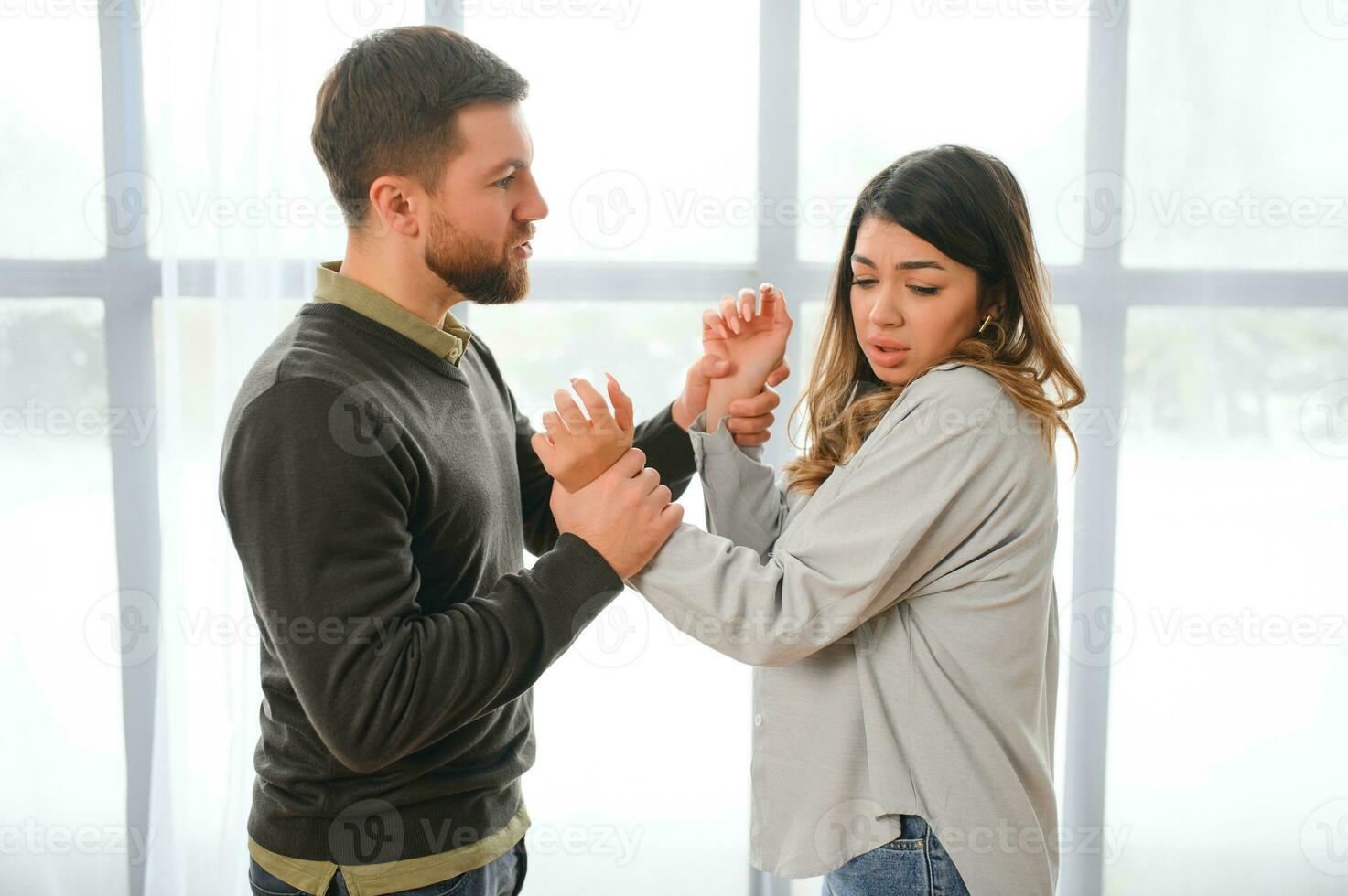 Man beating up his wife illustrating domestic violence photo