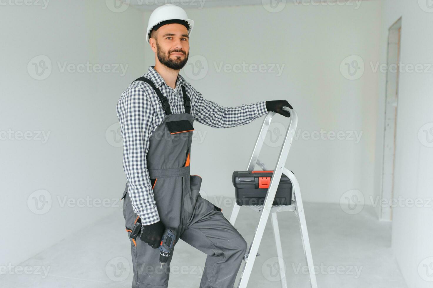 Young worker making repair in room. photo