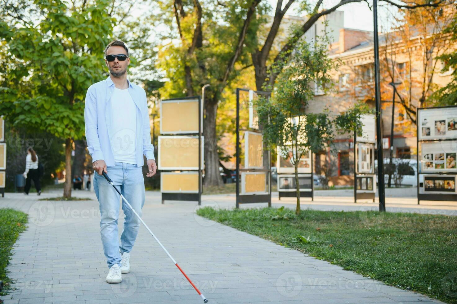 Blind man. Visually impaired man with walking stick, photo