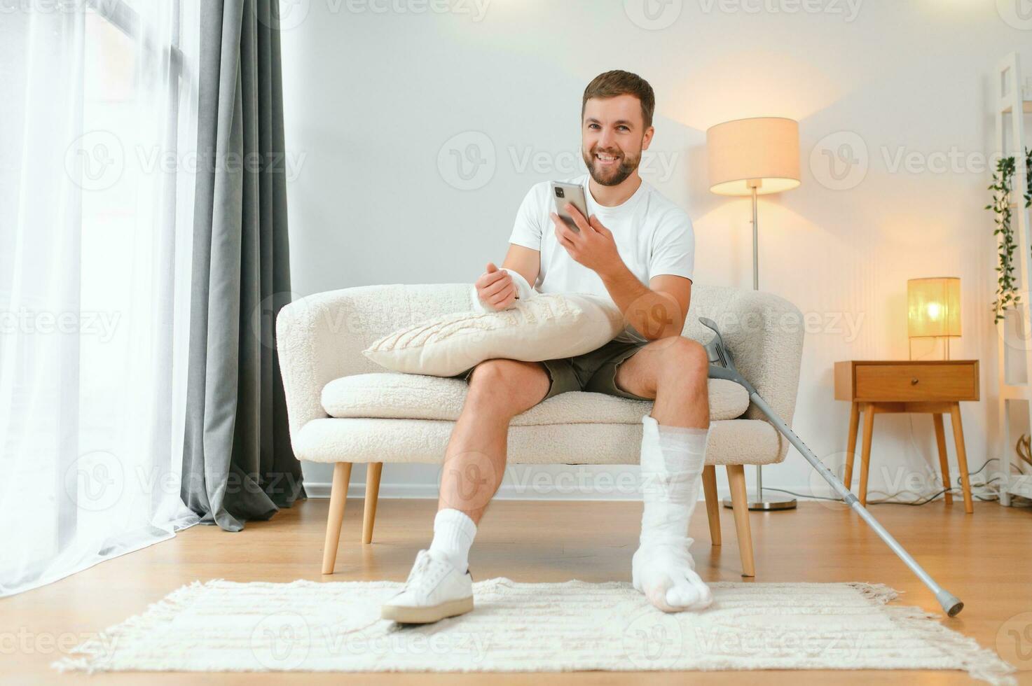 Happy man recovery from accident fracture broken bone injury with leg and arm. Social security and health insurance concept photo