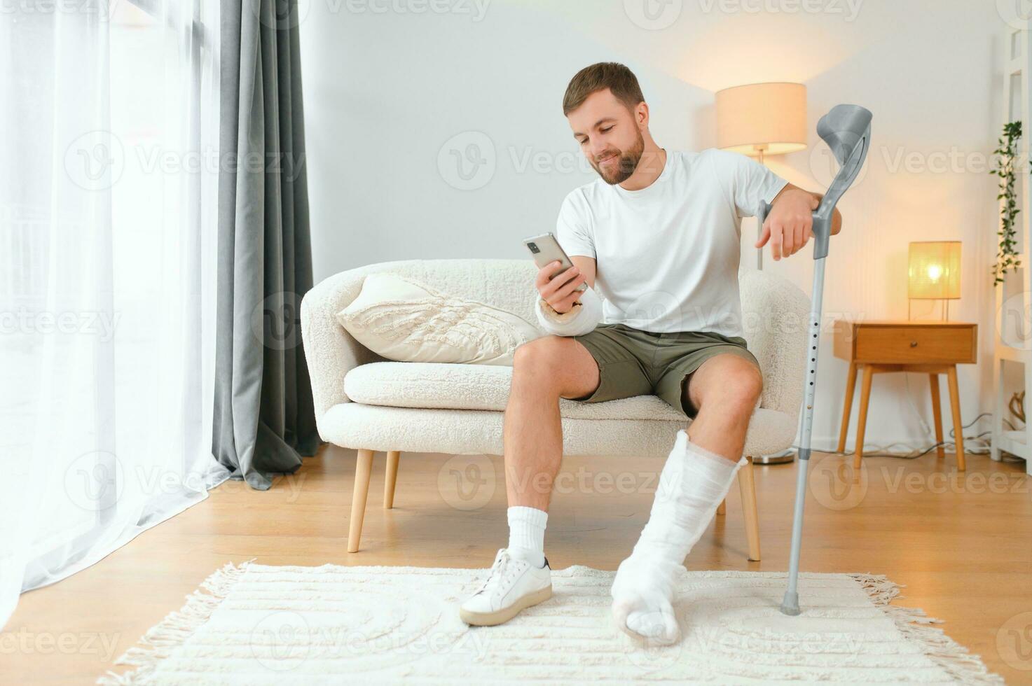 Happy man recovery from accident fracture broken bone injury with leg and arm. Social security and health insurance concept photo