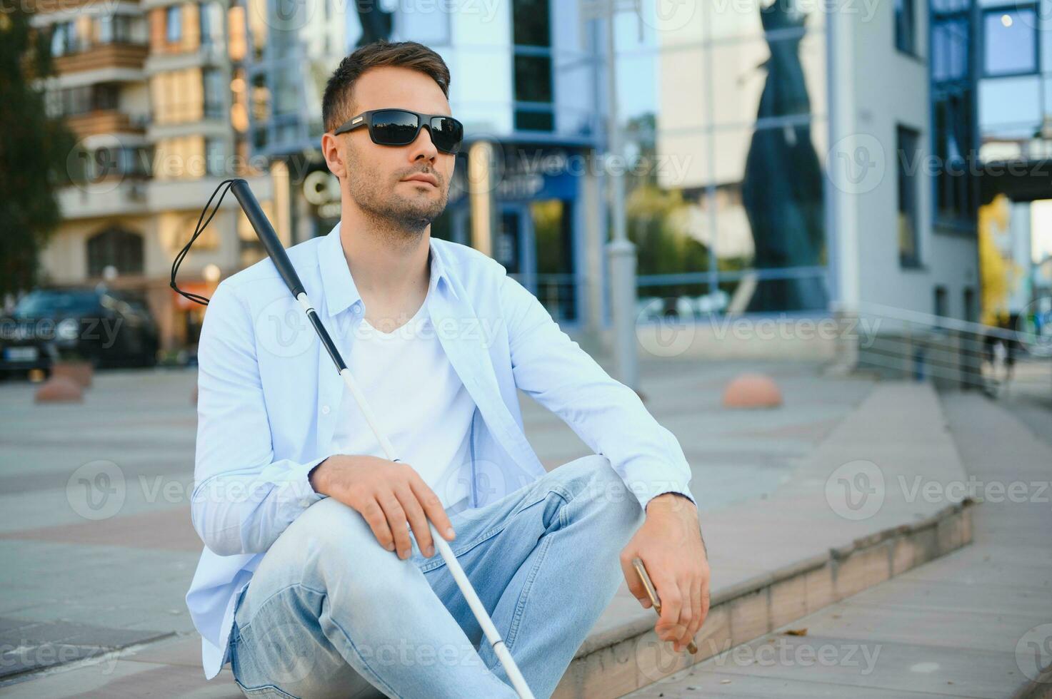 Blind man with a walking stick. photo