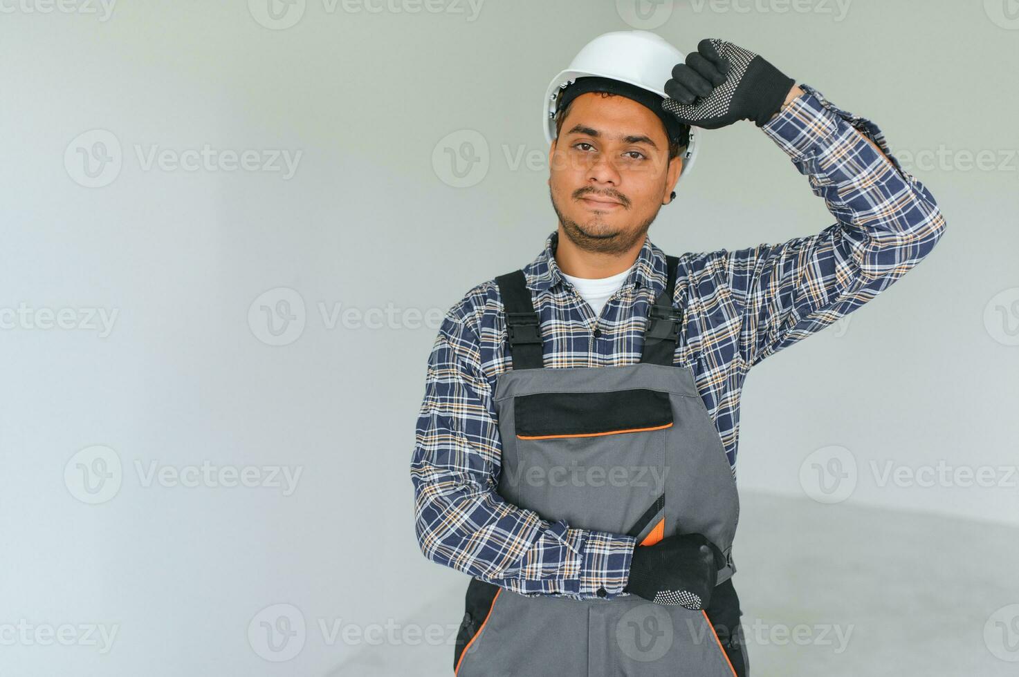 Indian worker makes repairs in an apartment photo