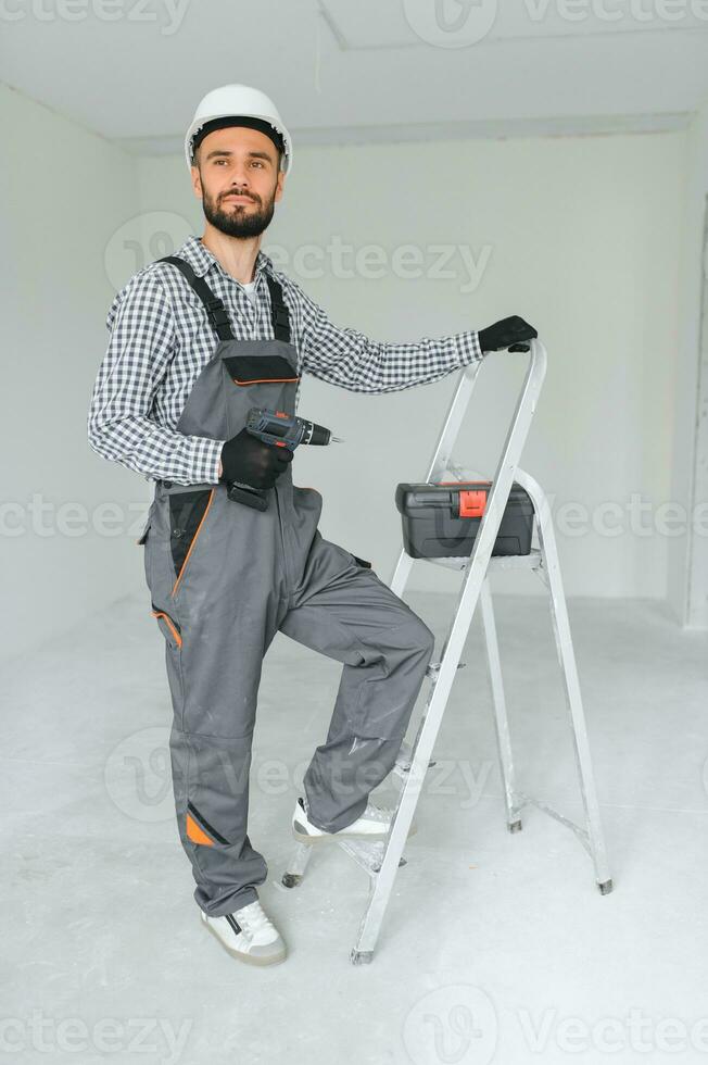 Portrait of a builder on a construction site indoors photo