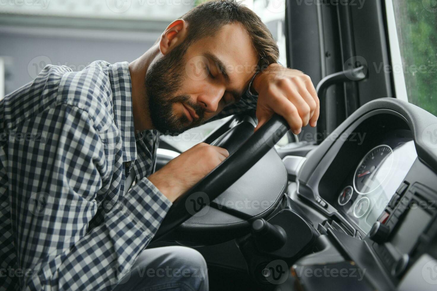 Portrait of tired truck driver feeling sleepy and sick. photo