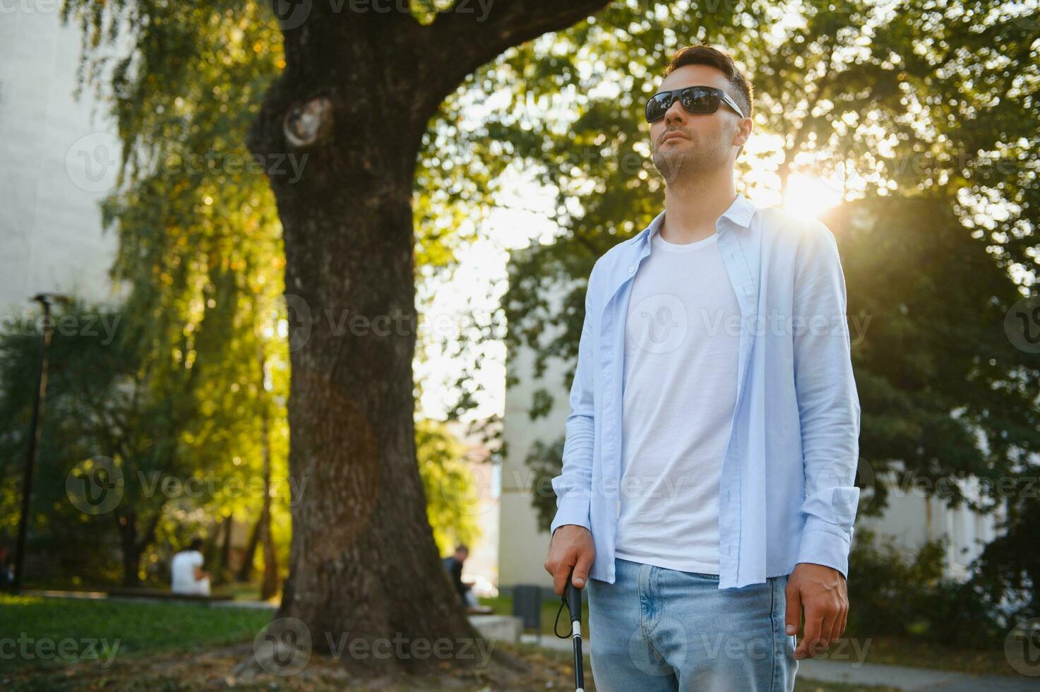 Blind man. Visually impaired man with walking stick, photo