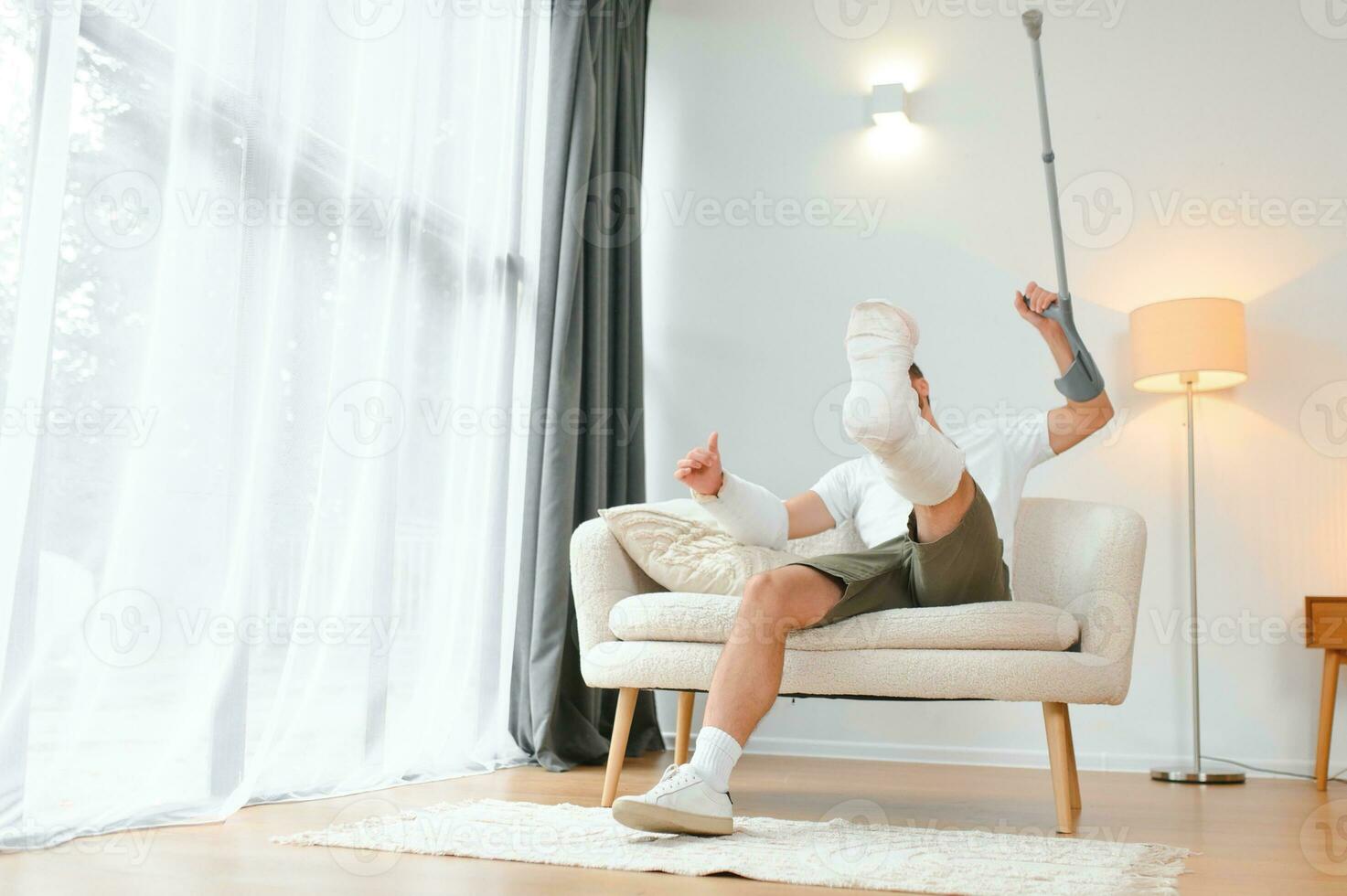 Happy man recovery from accident fracture broken bone injury with leg and arm. Social security and health insurance concept photo