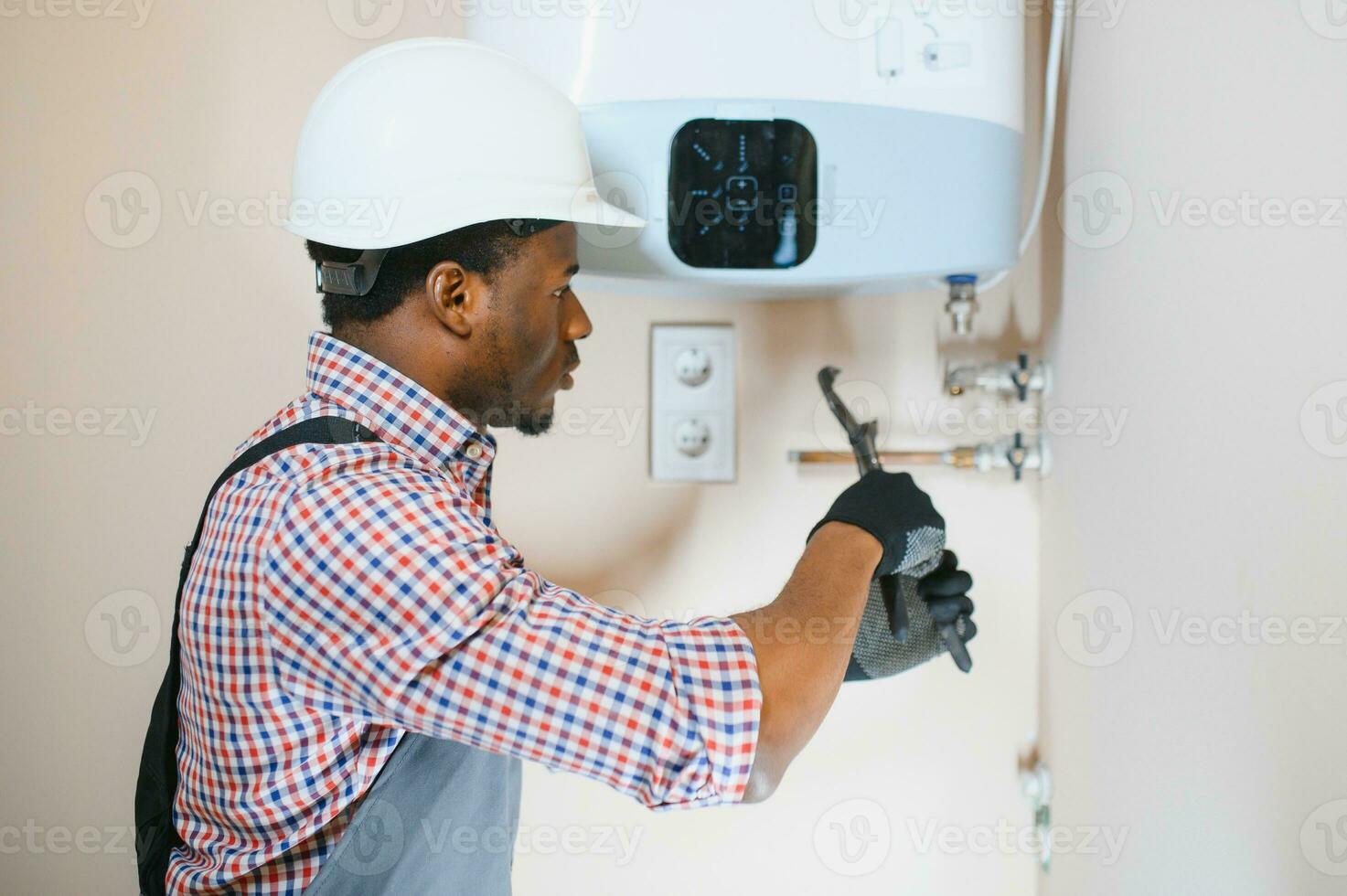 African american worker set up central gas heating boiler at home photo