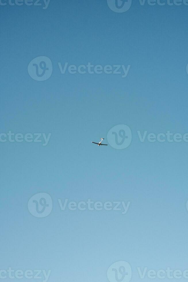 Jet Soaring Through Blue Sky photo