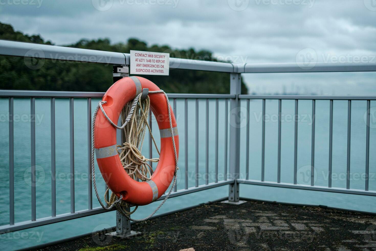 Orange Lifebuoy on Ocean Barricade photo