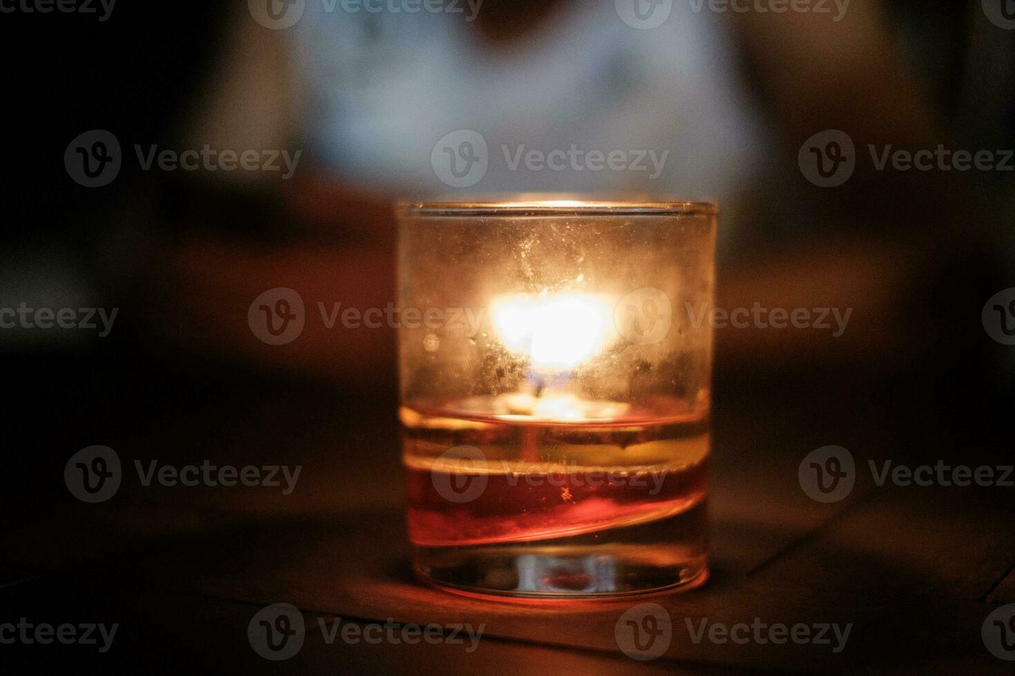 Lit Candle in Small Cup photo