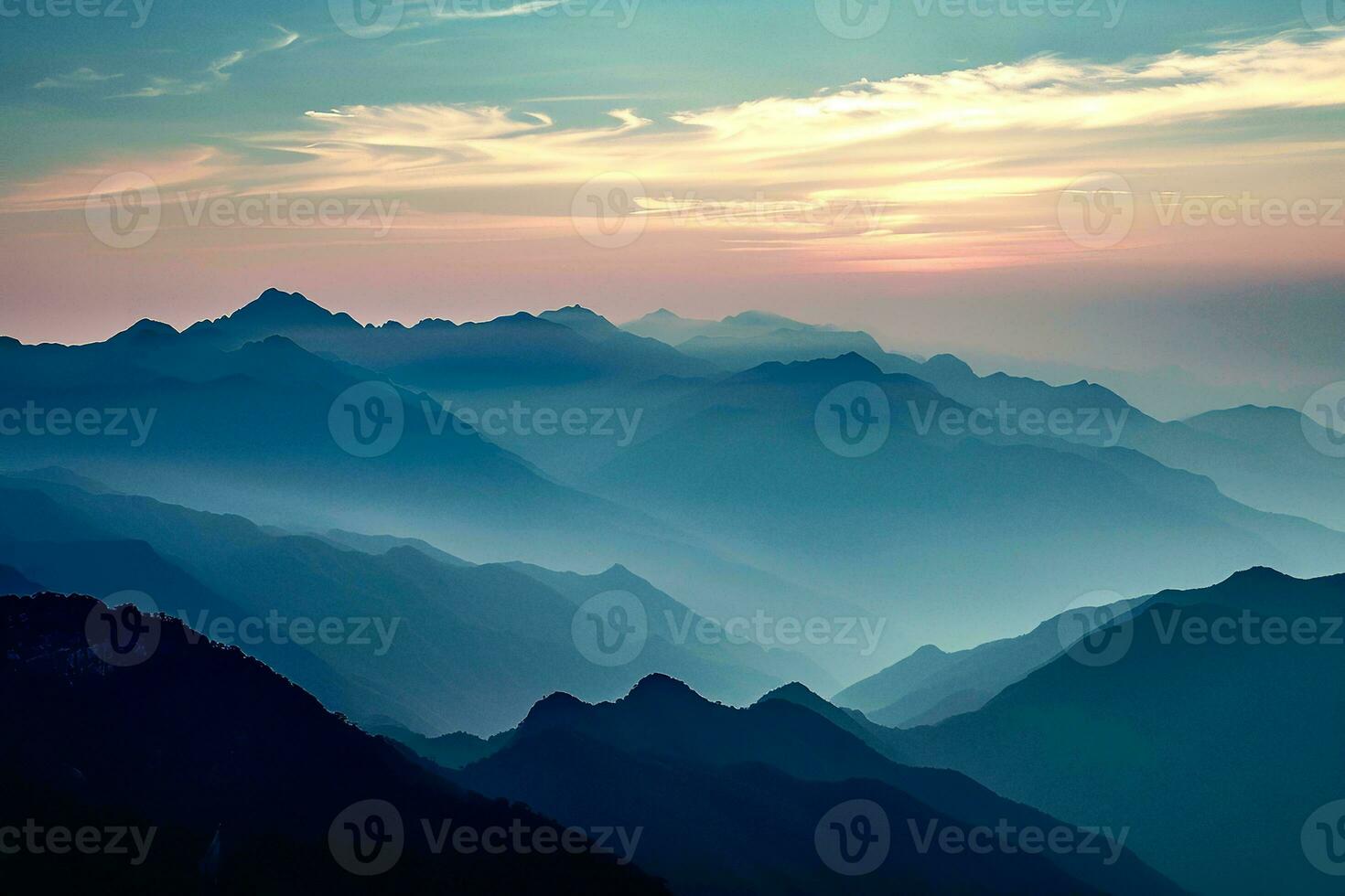 AI generated A tranquil scene of layered mountains bathed in the soft glow of sunset, showcasing nature's grandeur. photo