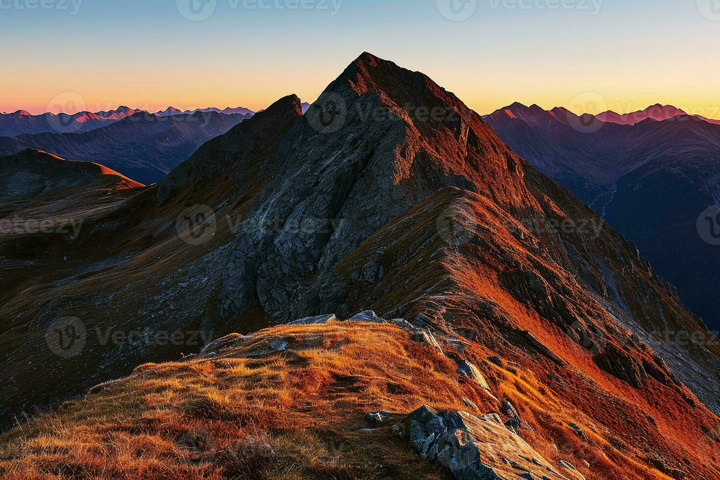 AI generated A breathtaking sunset illuminating majestic mountains, casting a golden glow on the rugged peaks and serene landscape. photo