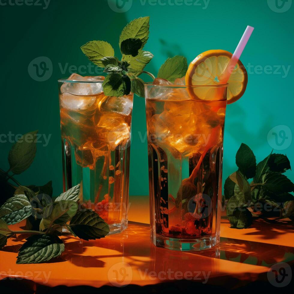 Glasses of iced tea with lemon slices and mint on a turquoise wooden background. photo