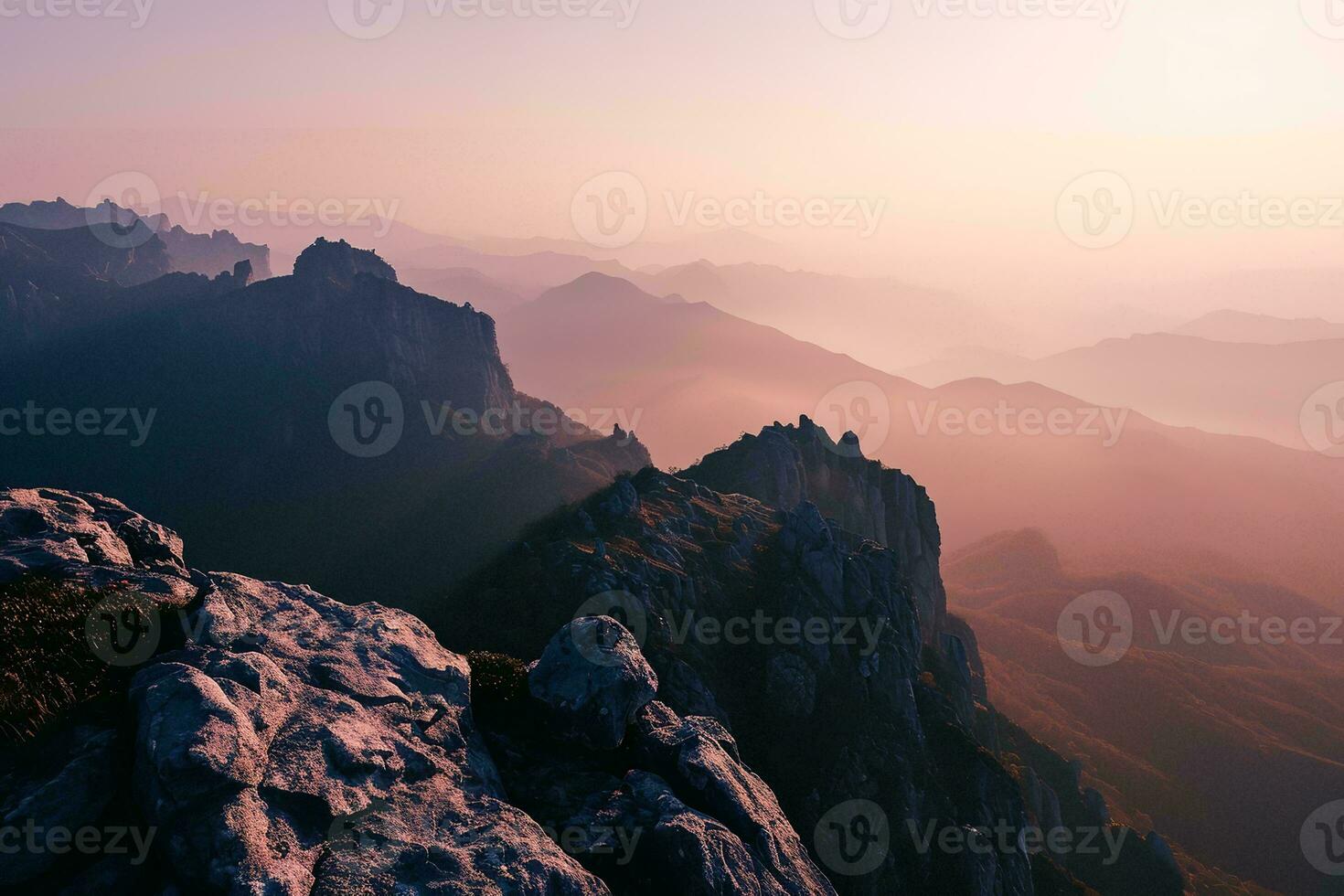 AI generated A breathtaking sunset over rugged mountains, with mist filling the valleys creating a serene and mystical atmosphere photo