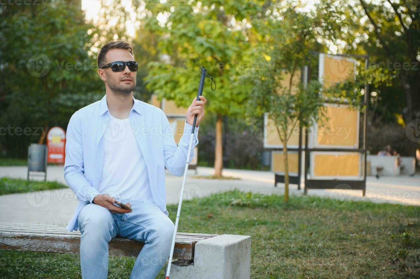 Blind man with a walking stick. photo