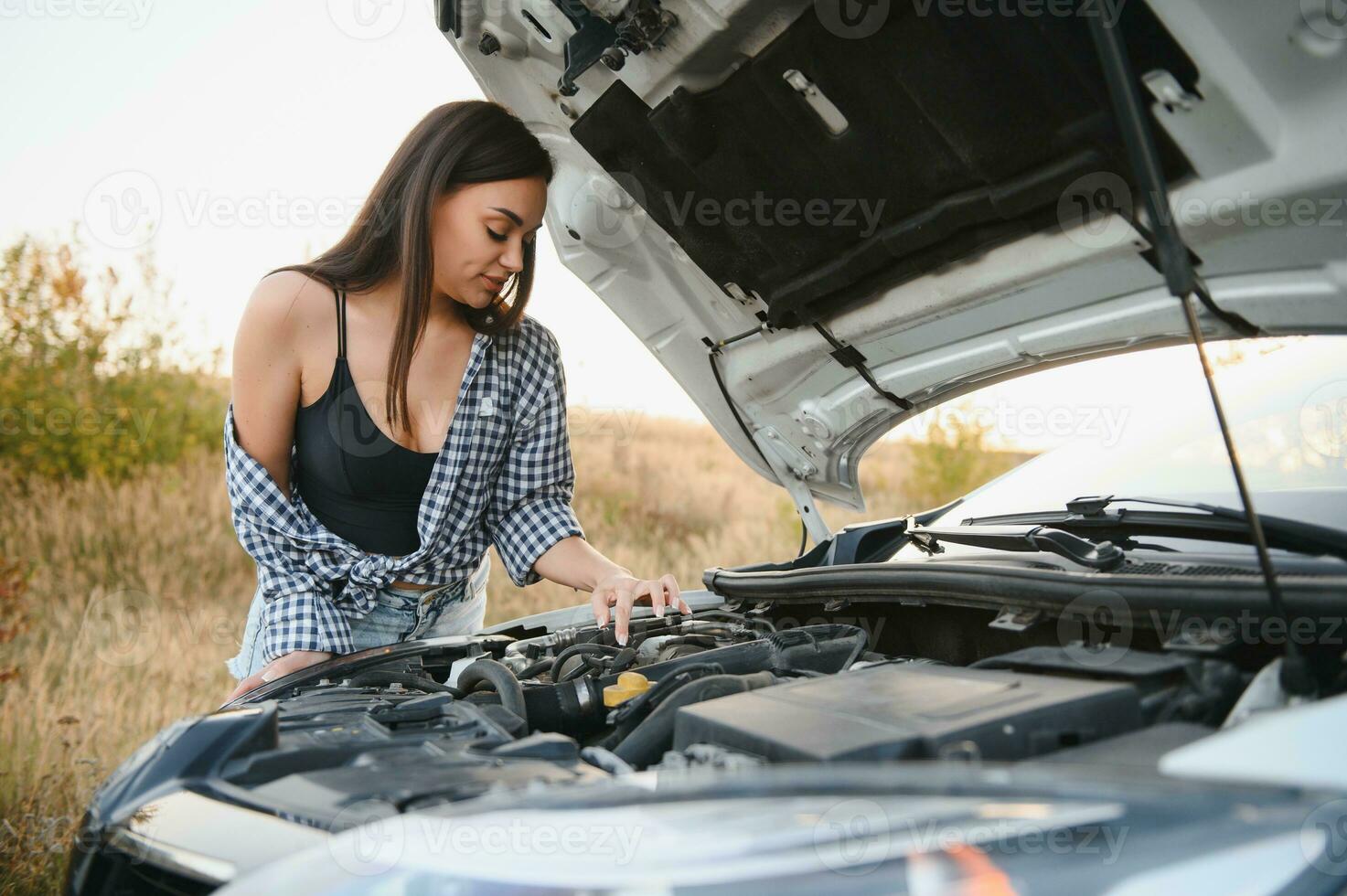 Sad woman depressed not knowing what to do with broken car photo