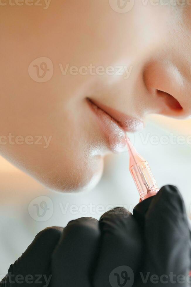 Banner Process woman applying permanent tattoo makeup on lips in beautician salon photo