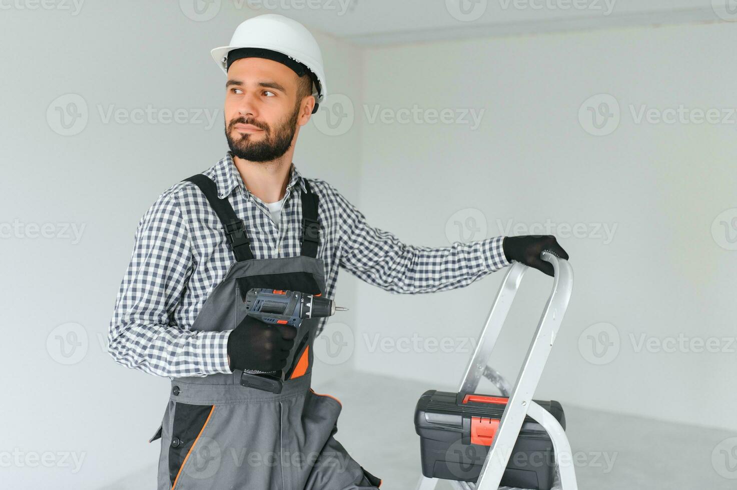 Young worker making repair in room. photo