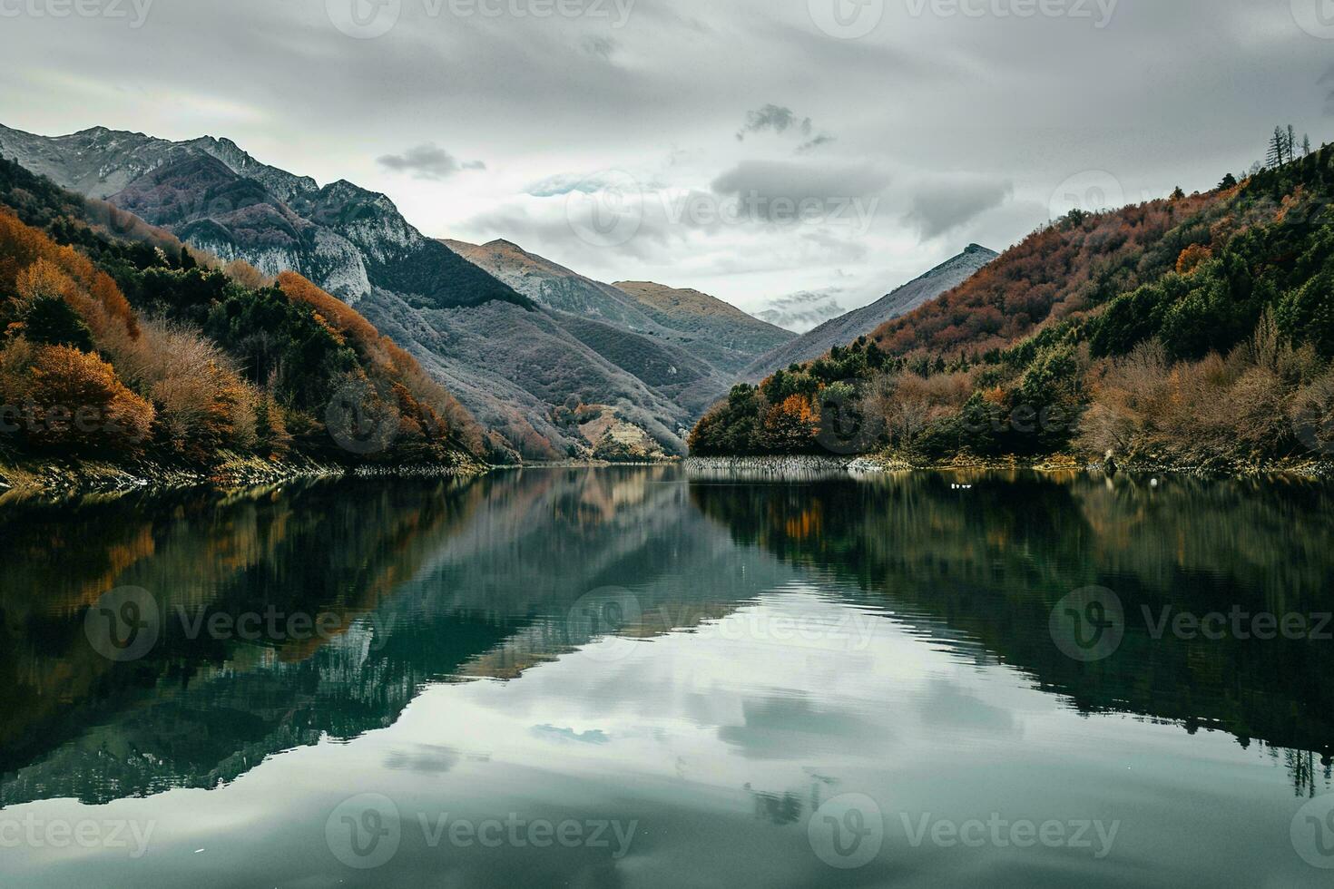 AI generated a tranquil scene of a lake surrounded by autumn-colored mountains under a cloudy sky, showcasing nature beauty. photo