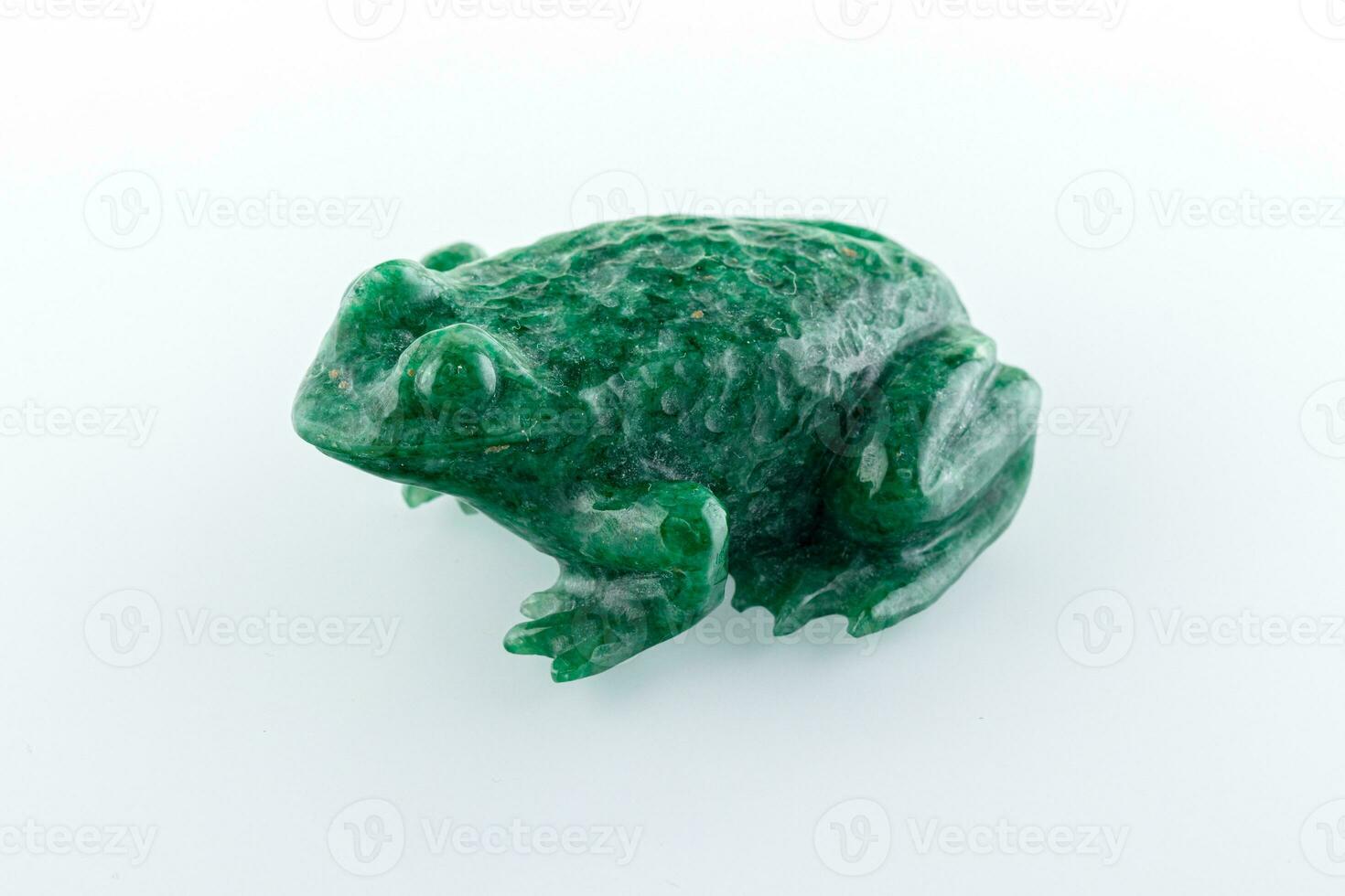 beautiful figurine of a toad made of malachite on a white background photo