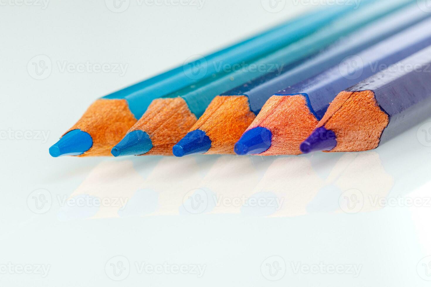 blue and violet pencil on white background photo