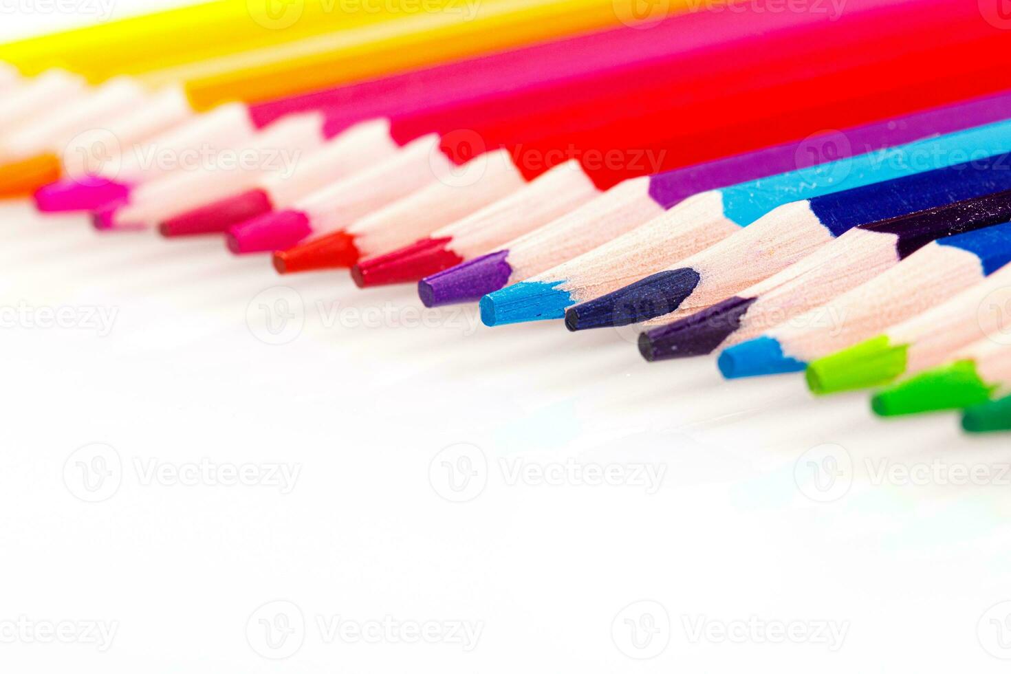 macro multicolored pencils on a white background photo