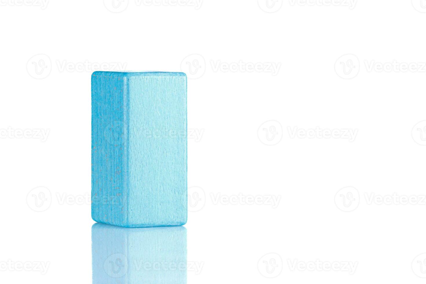 Wooden cube of blue color on a white background photo