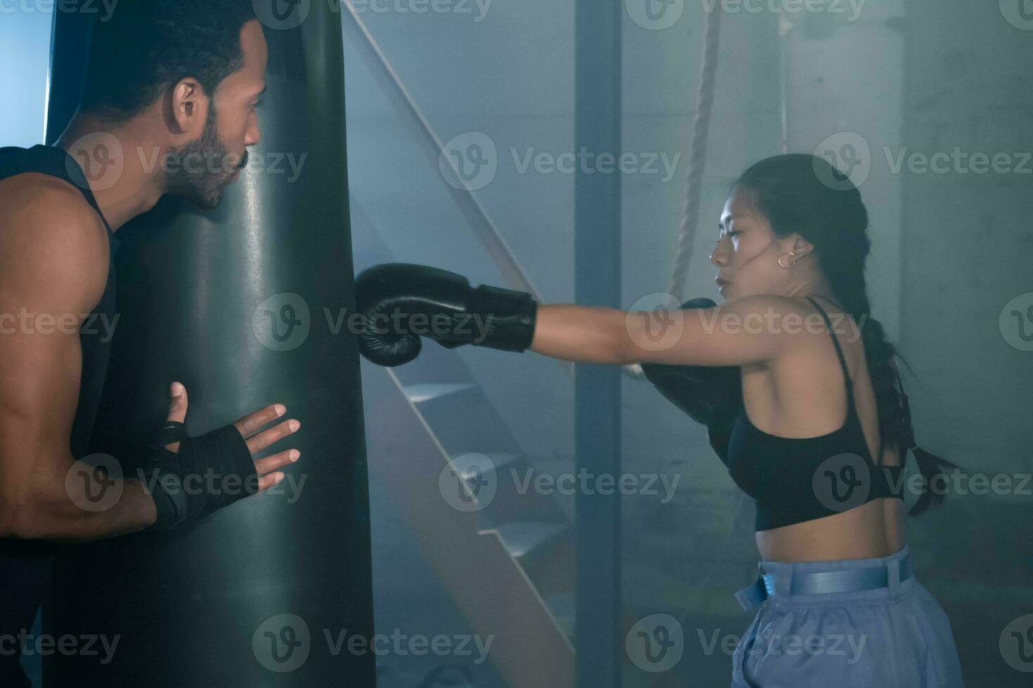 Fit and Strong Multicultural Couple Practicing Boxing Together in the Gym, Health and Unit concept photo