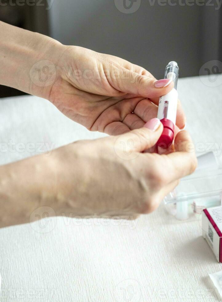 Close upshot of the woman preparing medicine for injection. Healthcare photo