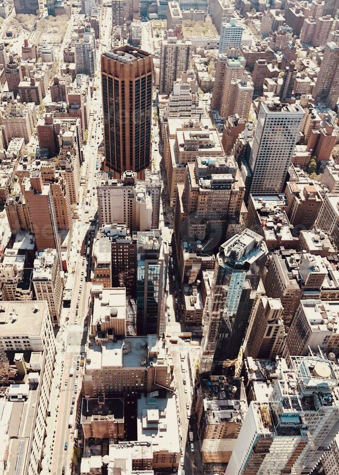 Aerial view of a dense urban cityscape with skyscrapers and buildings, showcasing architectural density and urban planning. photo