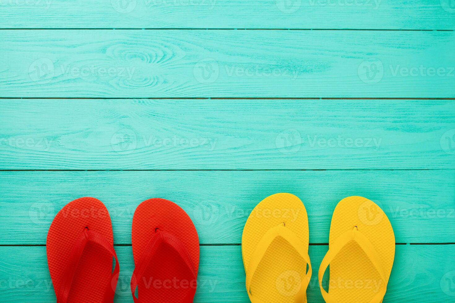 flip flops on blue wooden background with copy space. Top view. Mock up. Summer shoes sandals. Slippers photo