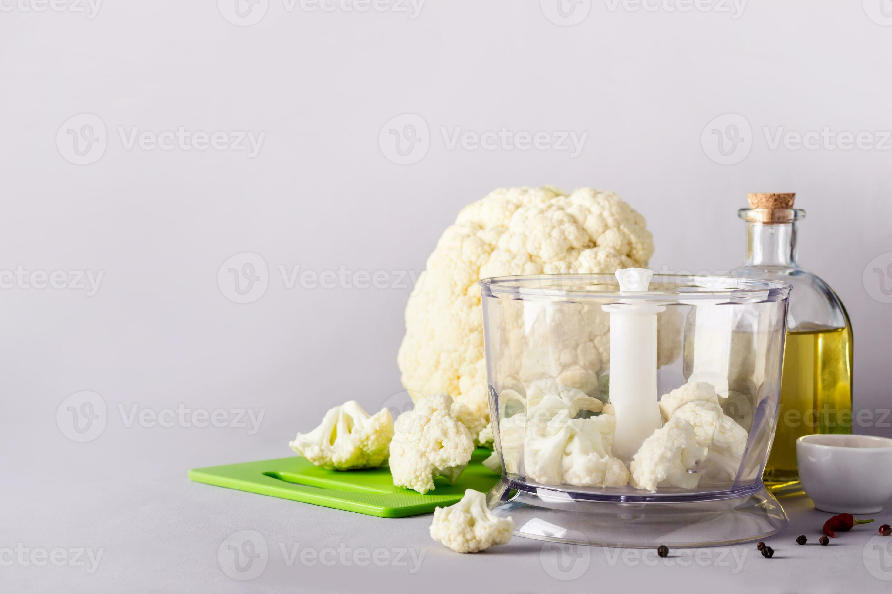 Cauliflower head and blender. Ingredients for Cooking Cauliflower Rice