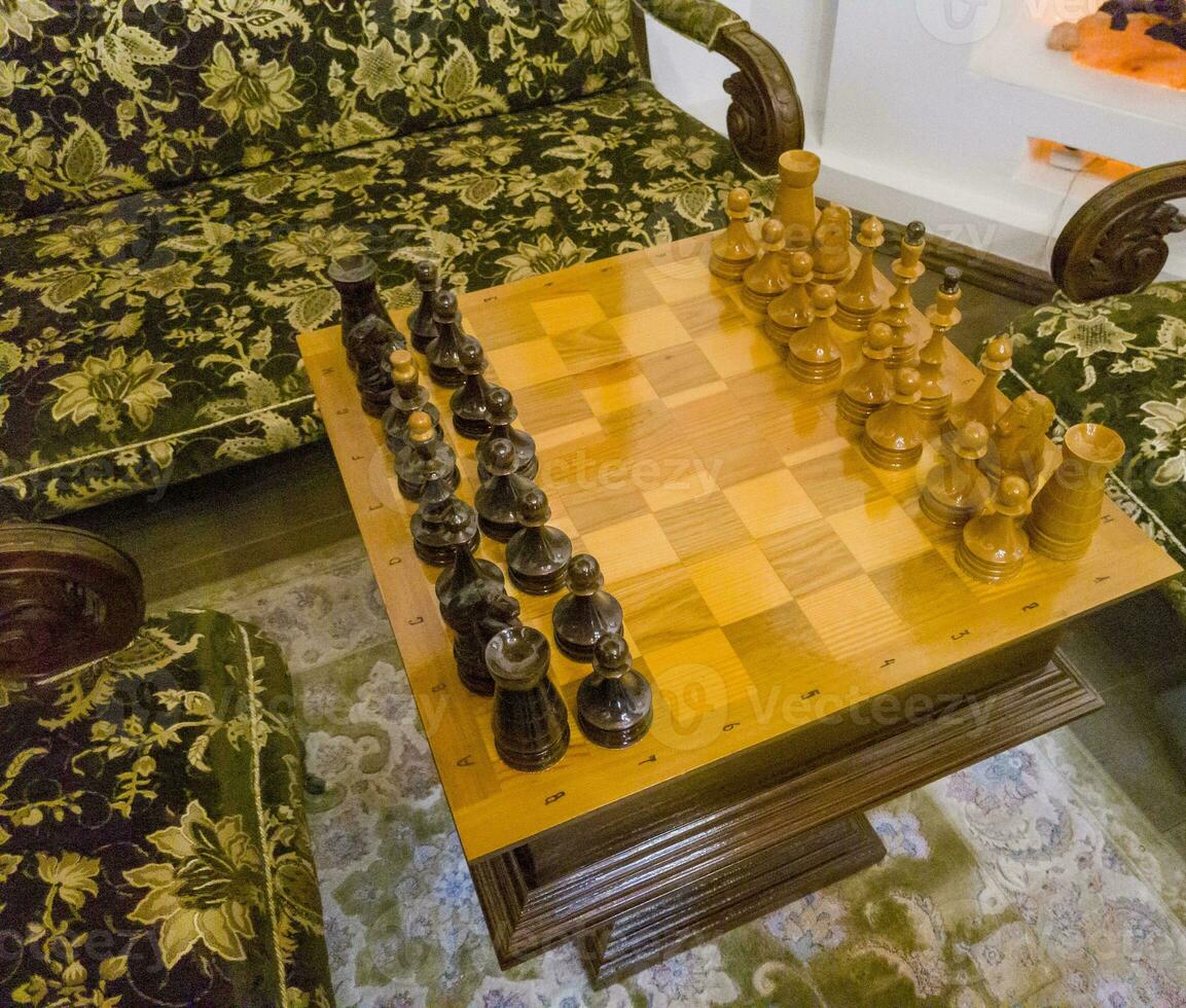 Shot of the vintage chessboard with black and white chess pieces. Concept photo