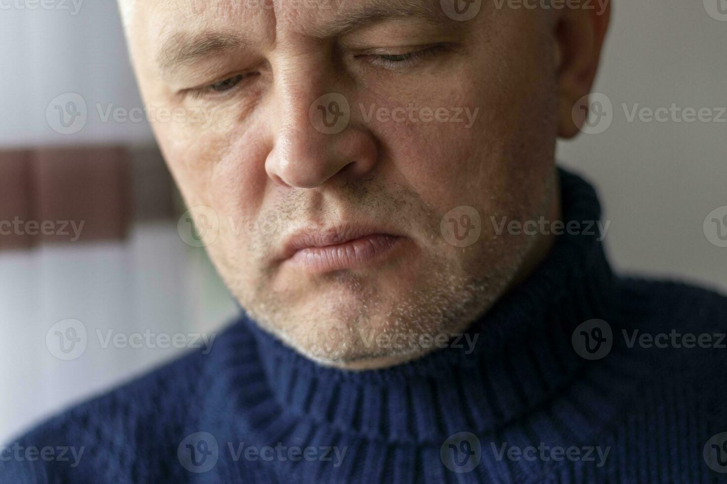 Portrait of the mid aged man with grey hair, wearing warm, dark blue sweater. People photo