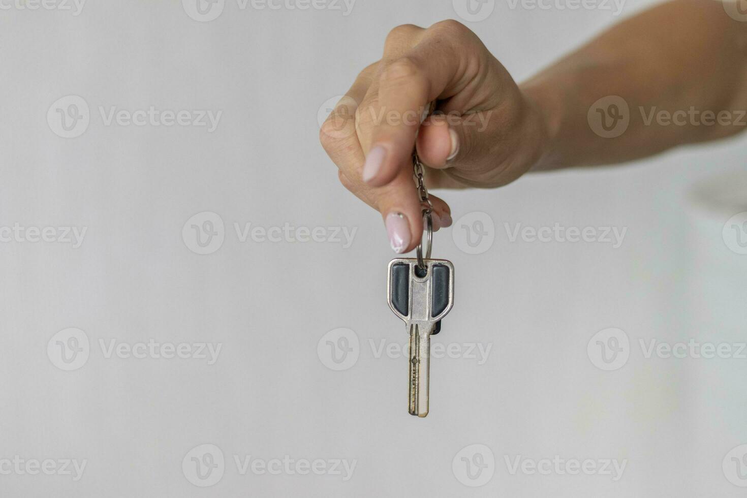 Close up shot of the woman's hand holding a key. Concept photo