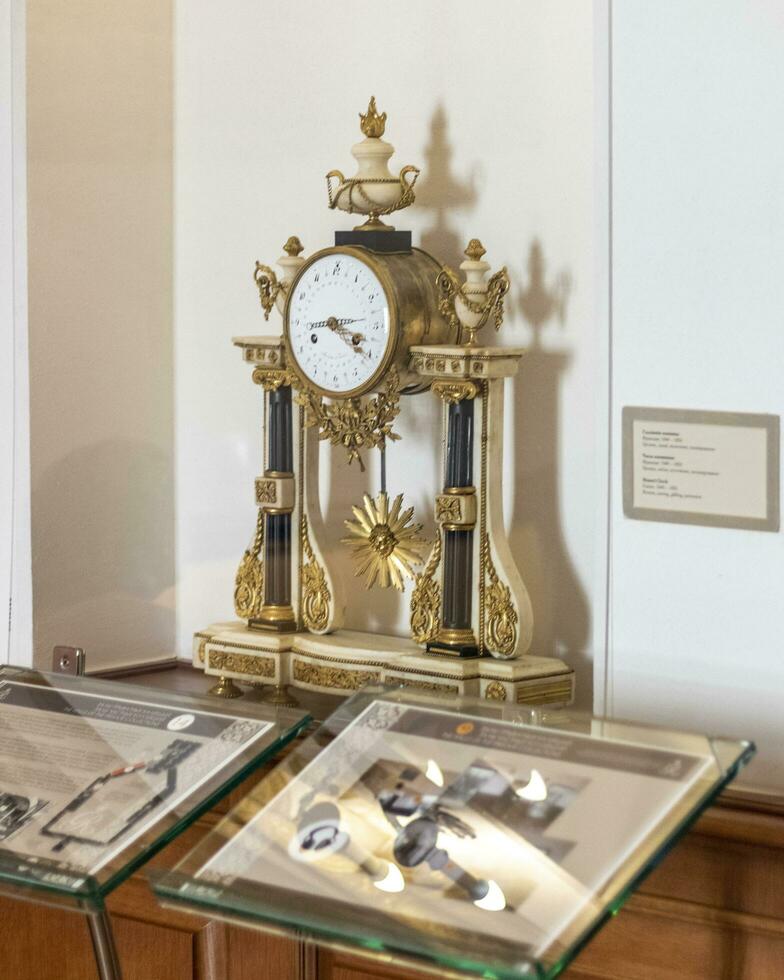 Nesvizh, Belarus - 08.23.2023 - Close up shot of the vintage clock on display of the museum of Radzwill castle. History photo