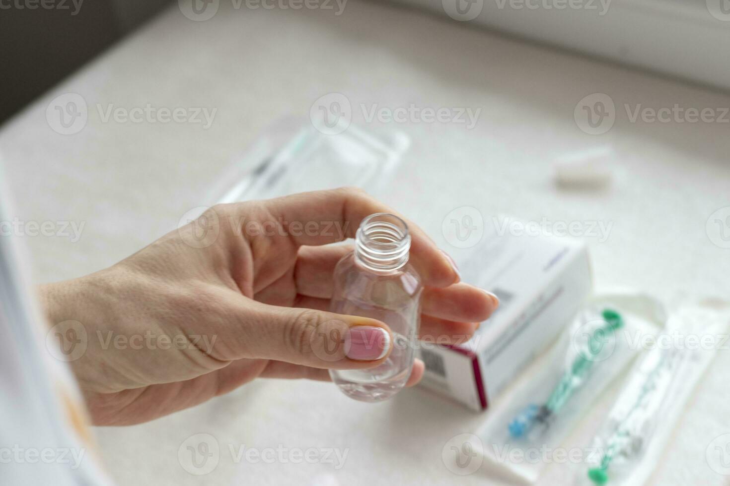 Close upshot of the woman preparing medicine for injection. Healthcare photo