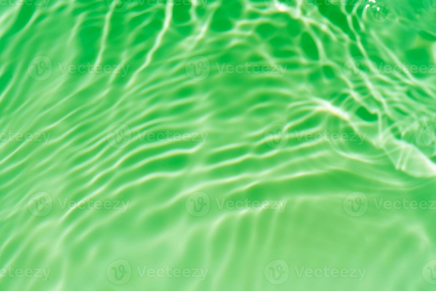 Bluewater waves on the surface ripples blurred. Defocus blurred transparent blue colored clear calm water surface texture with splash and bubbles. Water waves with shining pattern texture background. photo