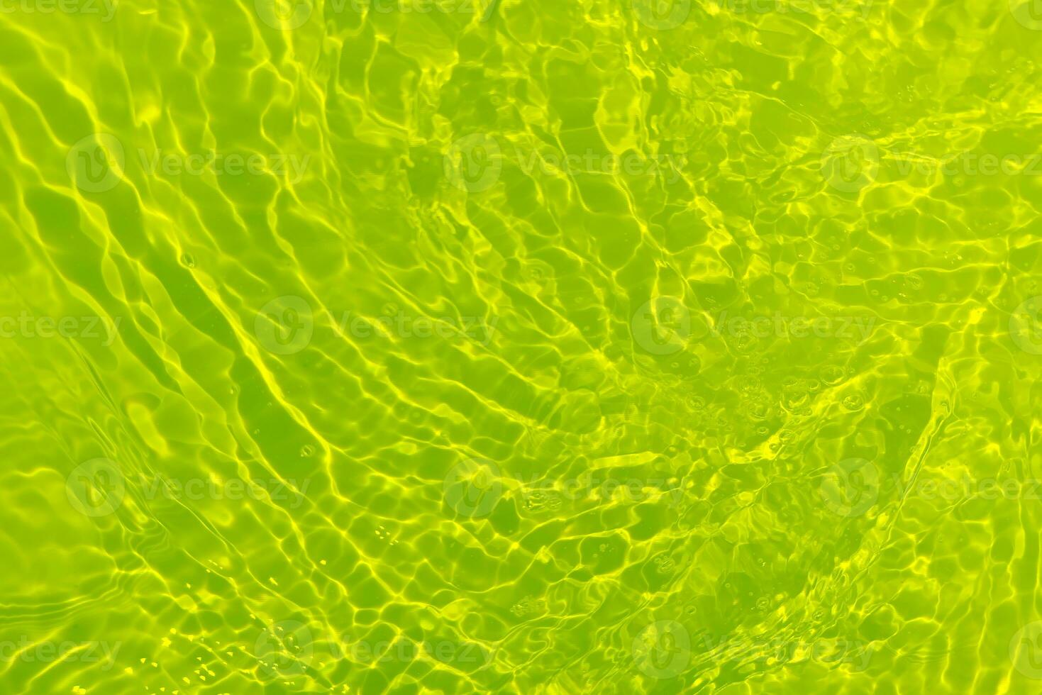 Green water waves on the surface ripple blurred. Defocus blurred transparent blue colored clear calm water surface texture with splash and bubbles. Water waves with shining pattern texture background. photo