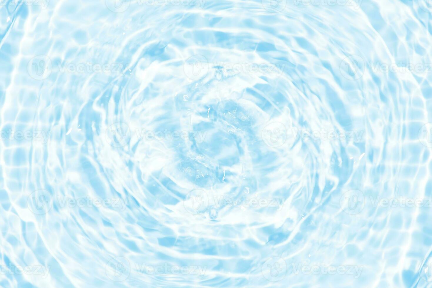 Defocus blurred transparent blue colored clear calm water surface texture with splashes and bubbles. Trendy abstract nature background. Water waves in sunlight with copy space. Blue watercolor shining photo