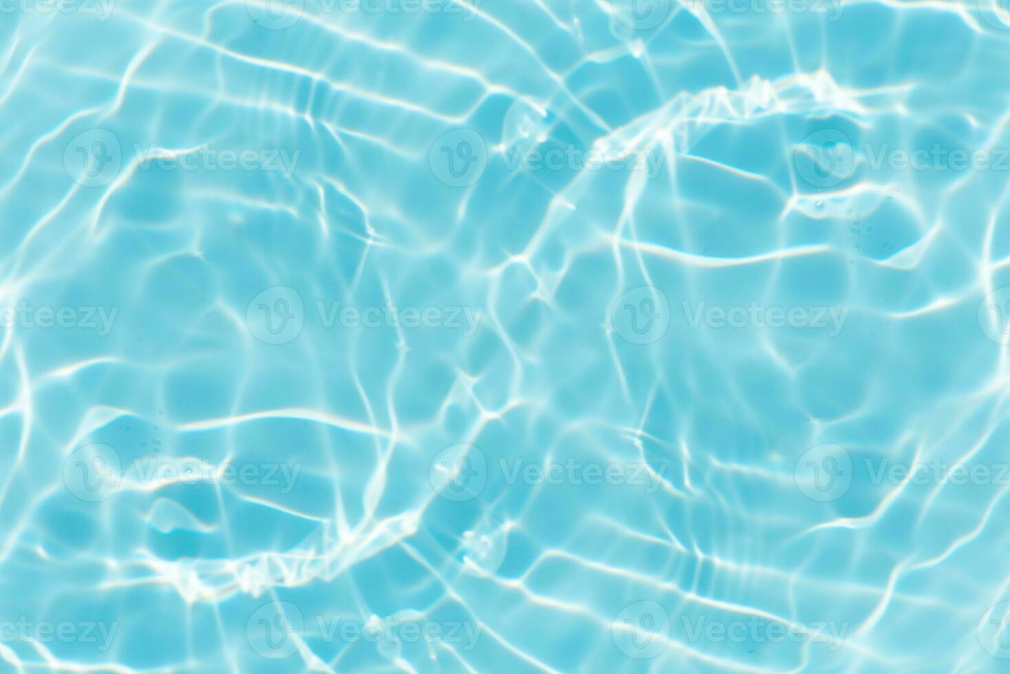 Bluewater waves on the surface ripples blurred. Defocus blurred transparent blue colored clear calm water surface texture with splash and bubbles. Water waves with shining pattern texture background. photo