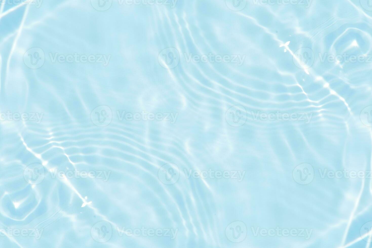 Defocus blurred transparent blue colored clear calm water surface texture with splashes and bubbles. Trendy abstract nature background. Water waves in sunlight with copy space. Blue watercolor shining photo