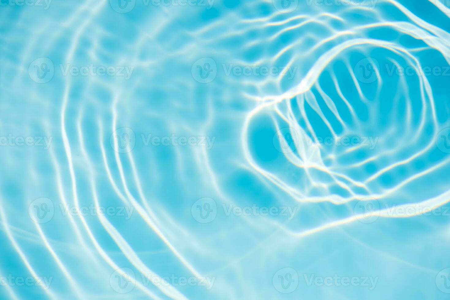 Defocus blurred transparent blue colored clear calm water surface texture with splashes and bubbles. Trendy abstract nature background. Water waves in sunlight with copy space. Blue watercolor shining photo