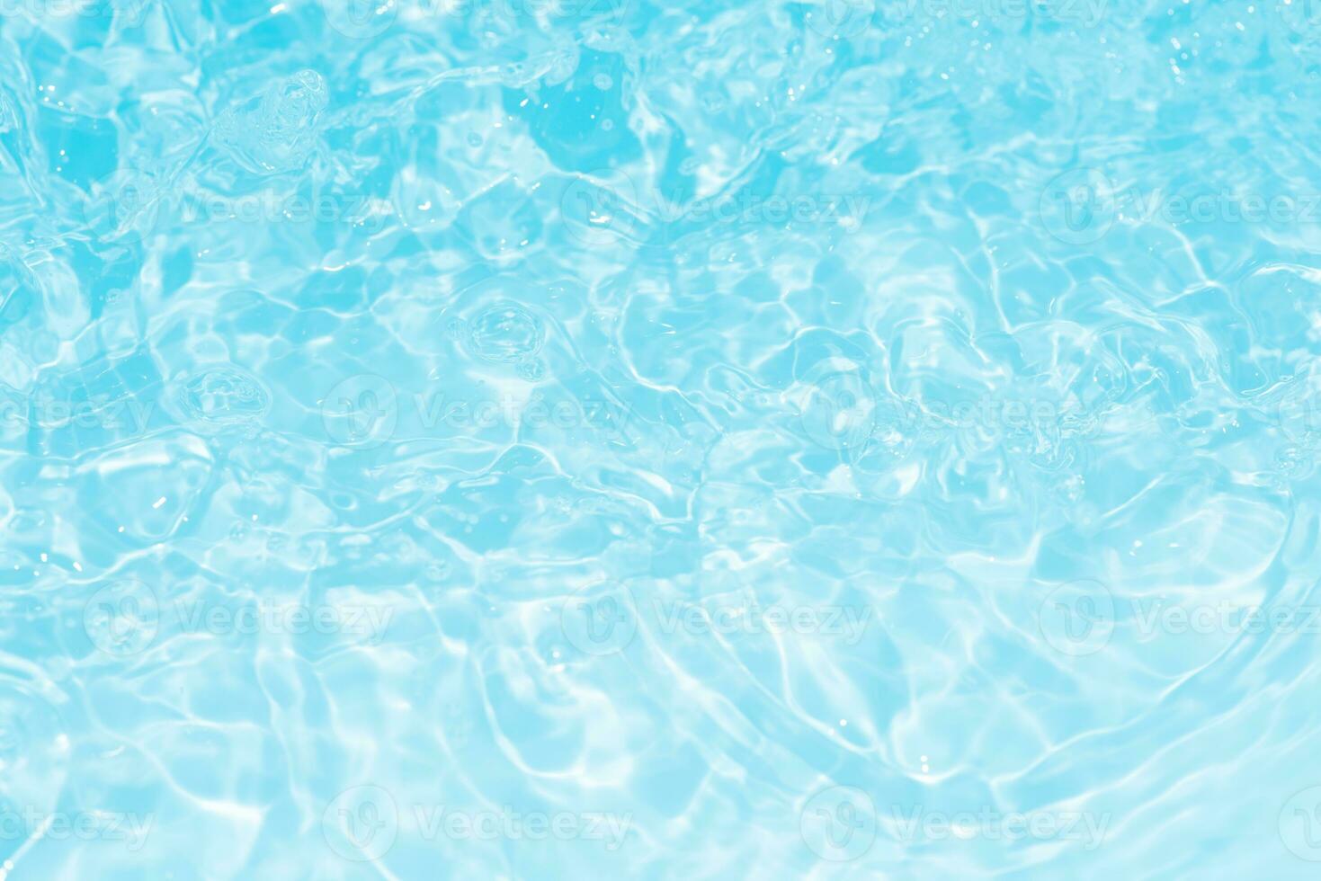 Bluewater waves on the surface ripples blurred. Defocus blurred transparent blue colored clear calm water surface texture with splash and bubbles. Water waves with shining pattern texture background. photo