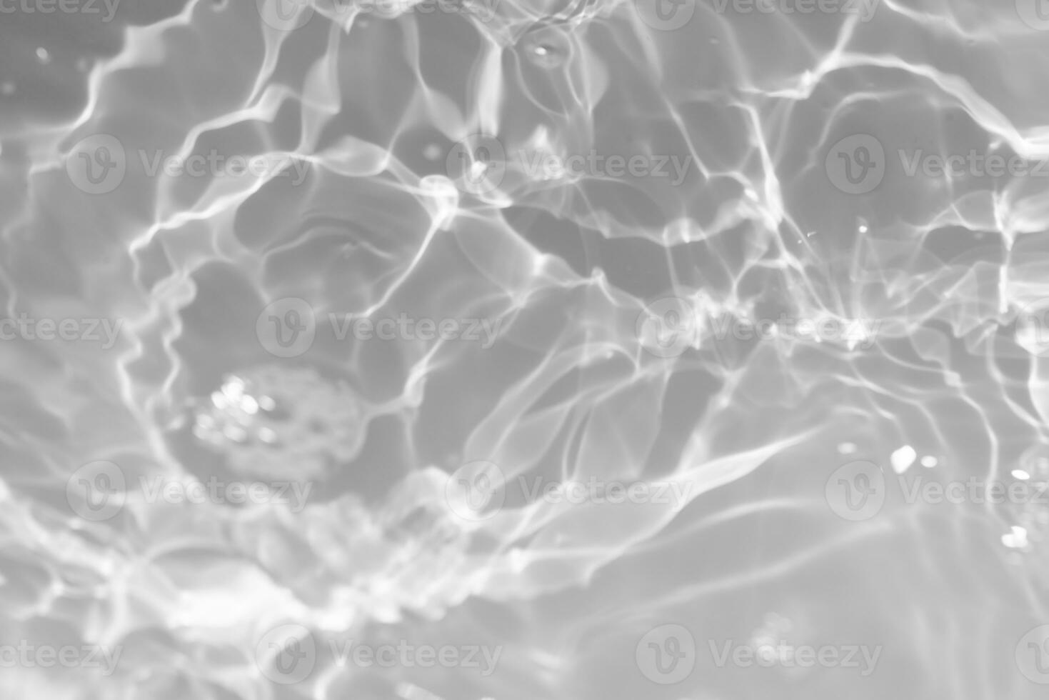 White water with ripples on the surface. Defocus blurred transparent white colored clear calm water surface texture with splashes and bubbles. Water waves with shining pattern texture background. photo
