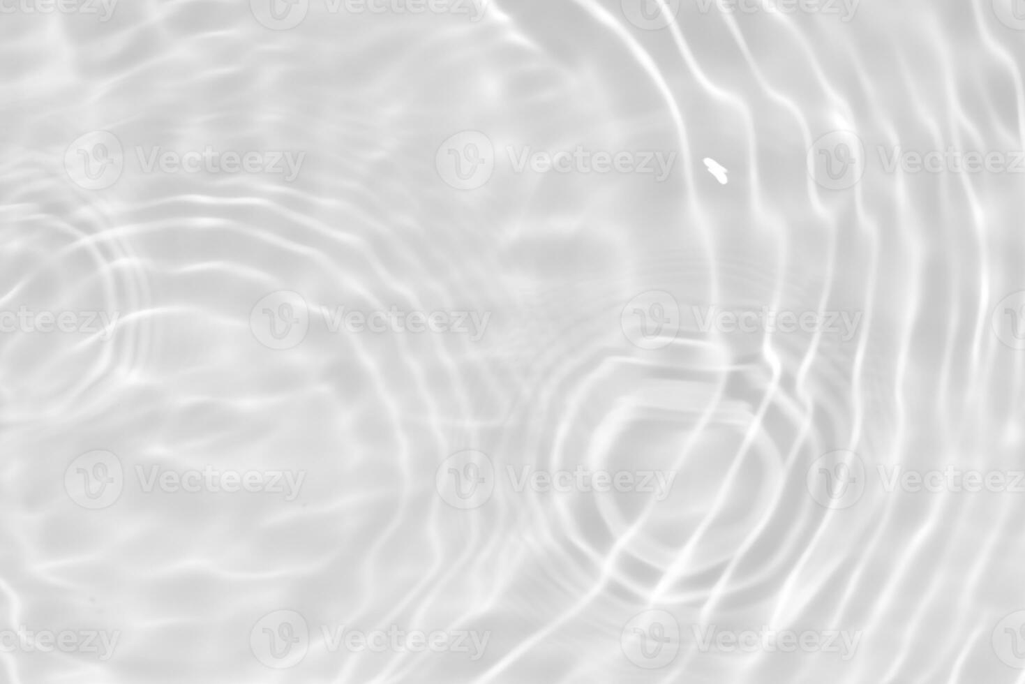 White water with ripples on the surface. Defocus blurred transparent white colored clear calm water surface texture with splashes and bubbles. Water waves with shining pattern texture background. photo